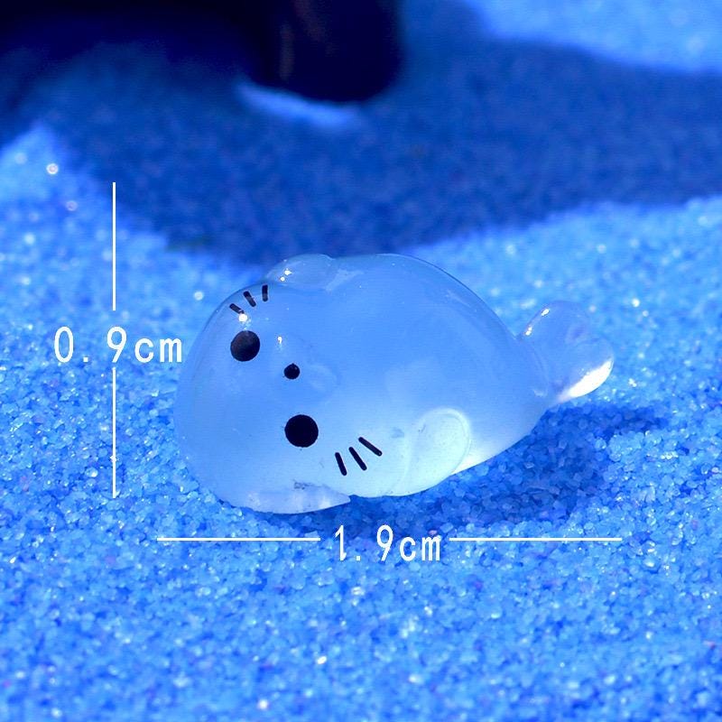 Glow in the dark seal pup resin charms approximately 17 by 10 mm
