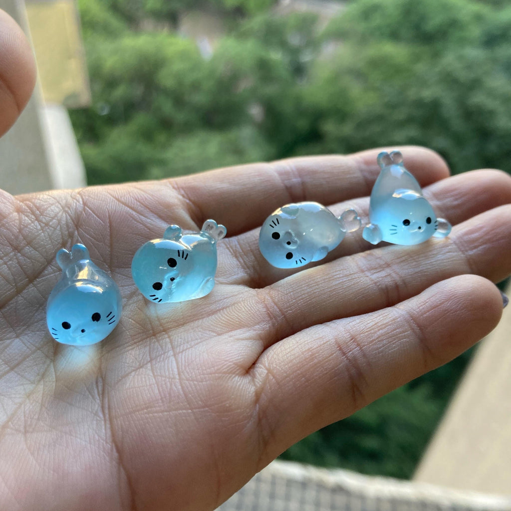 Glow in the dark seal pup resin charms approximately 17 by 10 mm