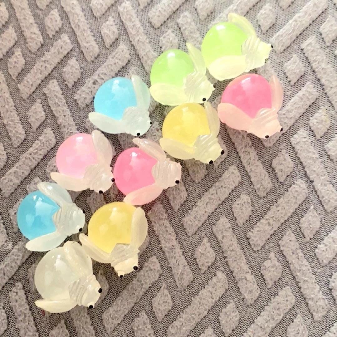Glow in the dark ladybug and firefly resin charms approximately 22 by 13 mm