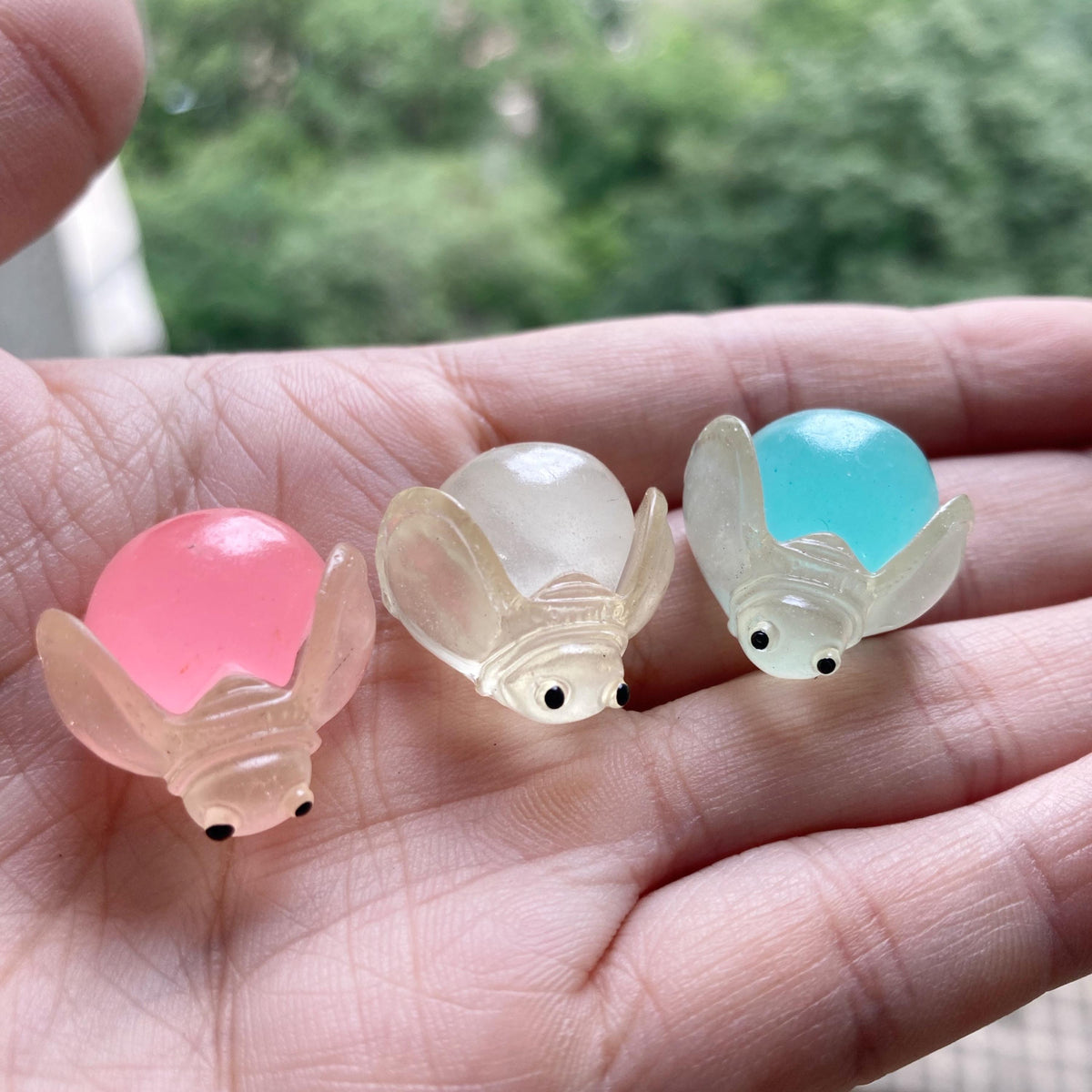 Glow in the dark ladybug and firefly resin charms approximately 22 by 13 mm